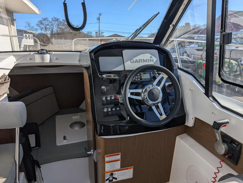 Slide: The Image of 2020 Jeanneau NC 795 boat cockpit with Garmin navigation system and modern steering wheel. - 29