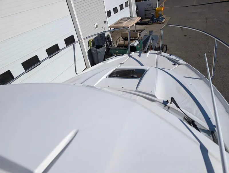 Slide: The Image of 2020 Jeanneau NC 795 boat deck view near a warehouse. - 33