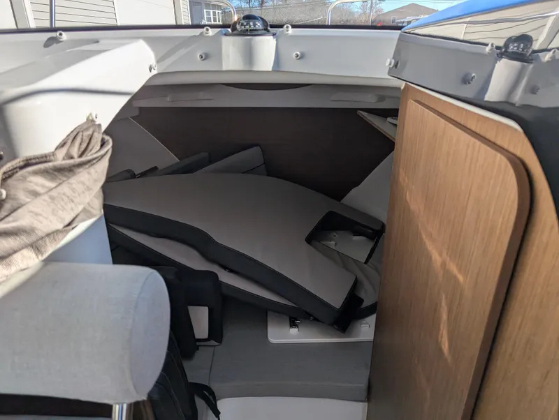 Slide: The Image of Interior cabin of 2020 Jeanneau NC 795 boat with cushions and wooden paneling. - 35