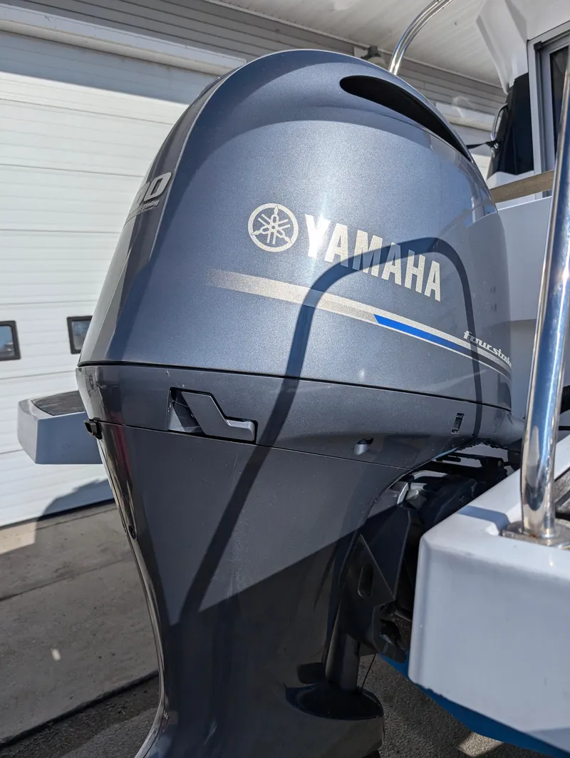 Slide: The Image of Yamaha outboard motor on 2020 Jeanneau NC 795 boat, docked outdoors. - 38