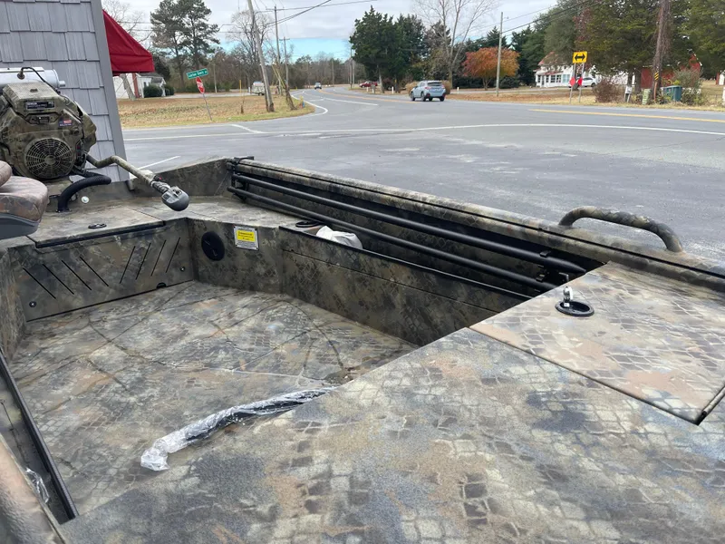 Slide: The Image of 2025 Excel Eclipse boat with camouflage design parked near a road. - 11