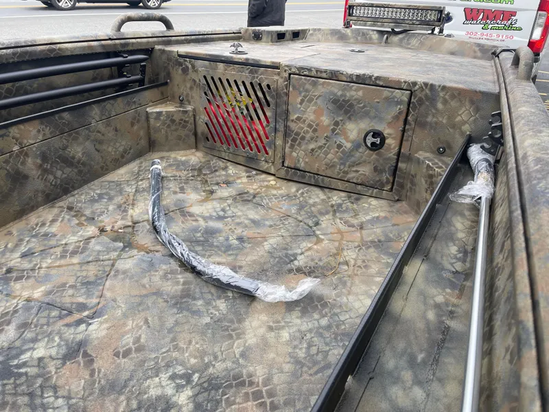 Slide: The Image of Camo-patterned interior of 2025 Excel Eclipse boat with storage compartment. - 14