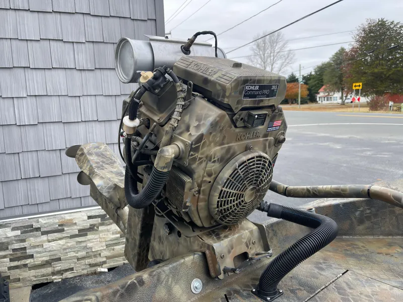 Slide: The Image of Camouflage-patterned Excel Eclipse 2025 boat motor with Kohler engine, outdoors. - 15