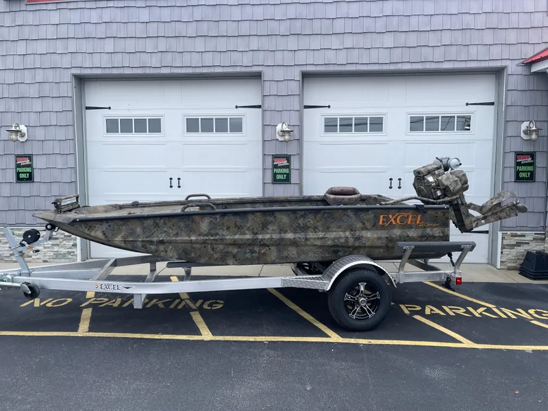 Slide: The Image of 2025 Excel Eclipse boat on trailer, parked in front of garage doors. - 3