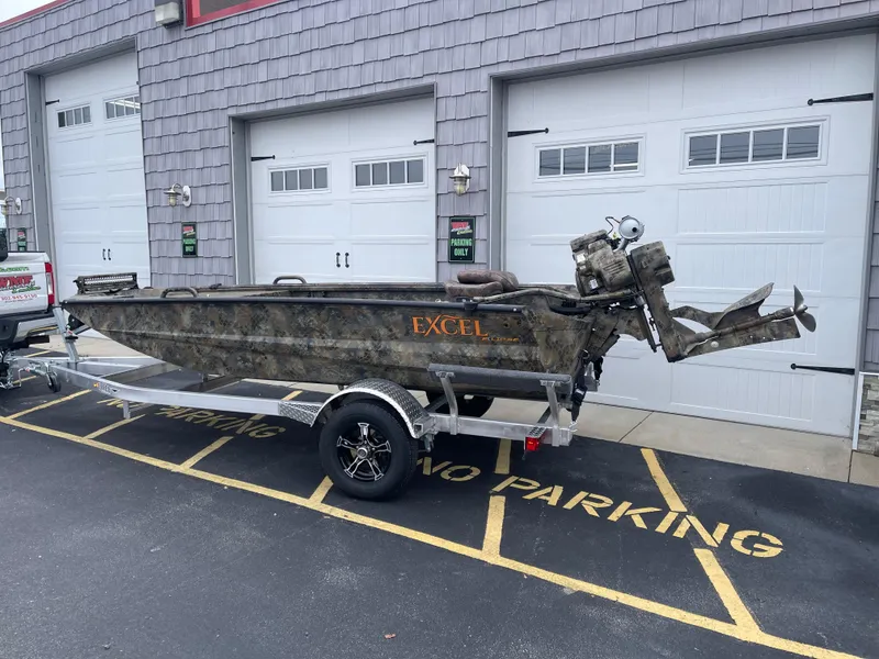 Slide: The Image of 2025 Excel Eclipse boat on trailer, parked outside garage. - 4