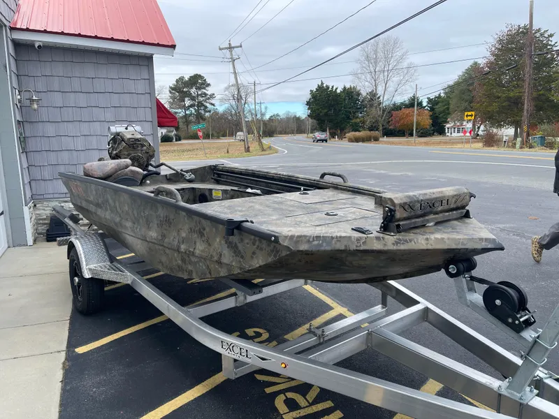 Slide: The Image of 2025 Excel Eclipse boat on trailer, parked near a road. - 7