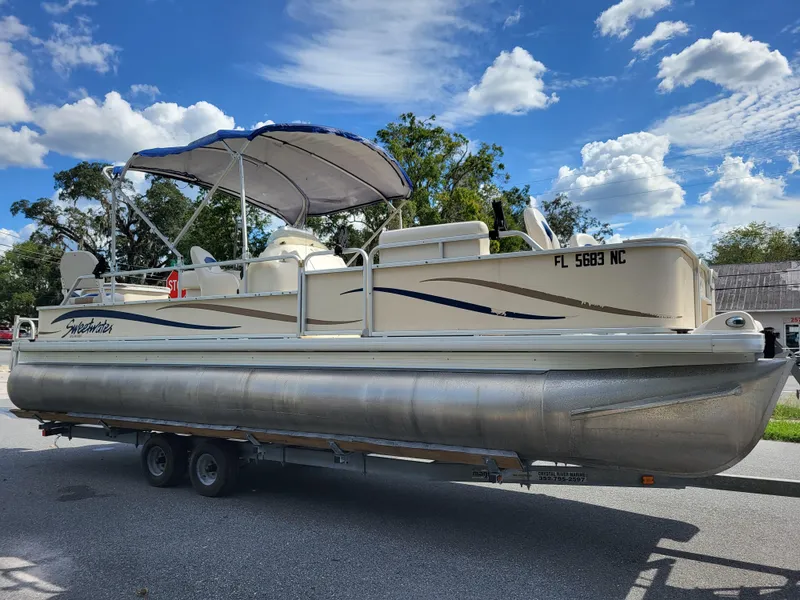 Slide: The Image of 2006 Godfrey Sweetwater 2586DF pontoon boat on trailer under blue sky. - 1