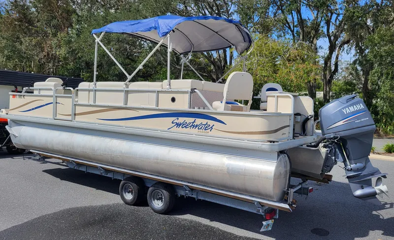 Slide: The Image of 2006 Godfrey Sweetwater 2586DF pontoon boat with Yamaha motor and blue canopy. - 4
