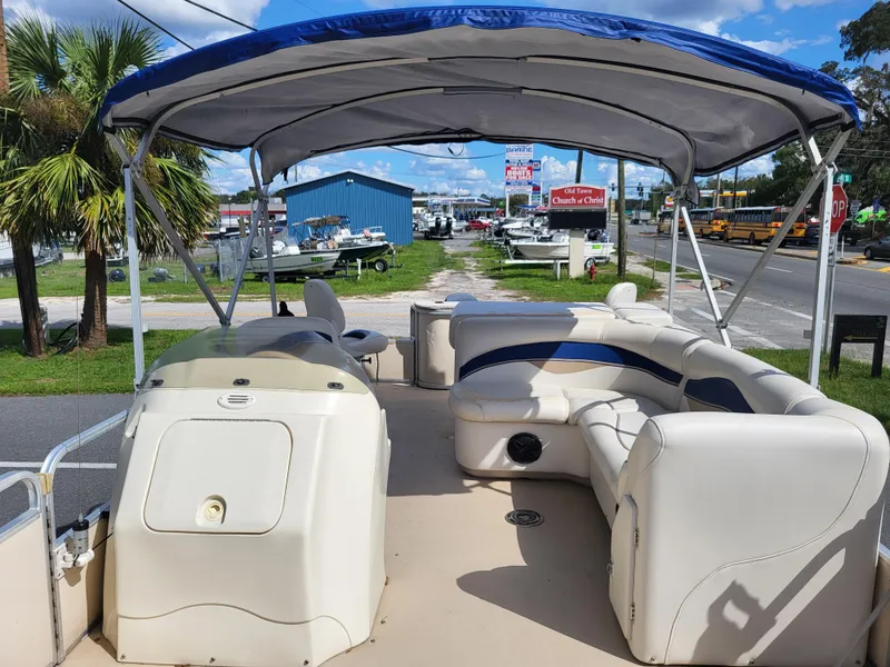 Slide: The Image of 2006 Godfrey Sweetwater 2586DF pontoon boat with canopy and seating, parked outdoors. - 9