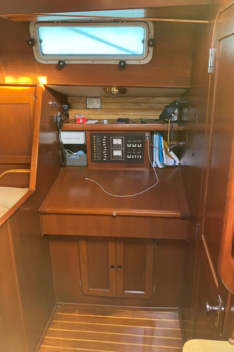 Slide: The Image of 1983 Morgan Nelson Marek 454 yacht interior with navigation station and wooden cabinetry. - 11