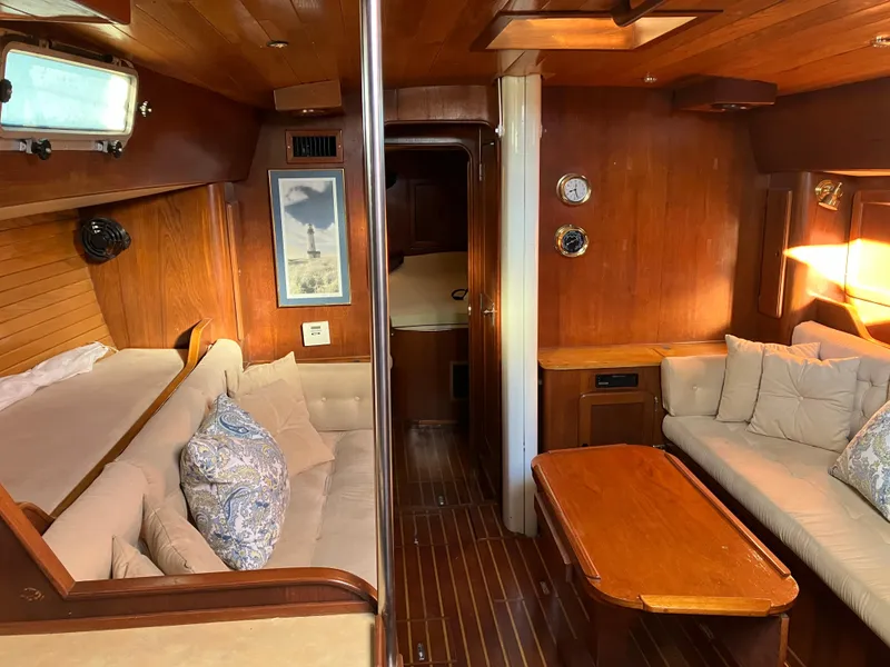 Slide: The Image of Interior of 1983 Morgan NELSON MAREK 454 sailboat with wooden furnishings and cozy seating. - 20