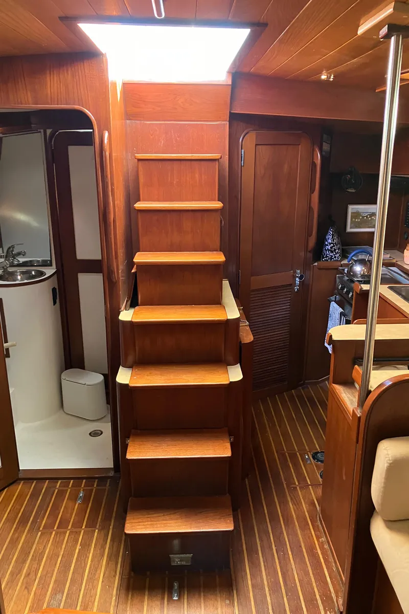 Slide: The Image of Interior of 1983 Morgan Nelson Marek 454 sailboat with wooden stairs and cabin. - 22
