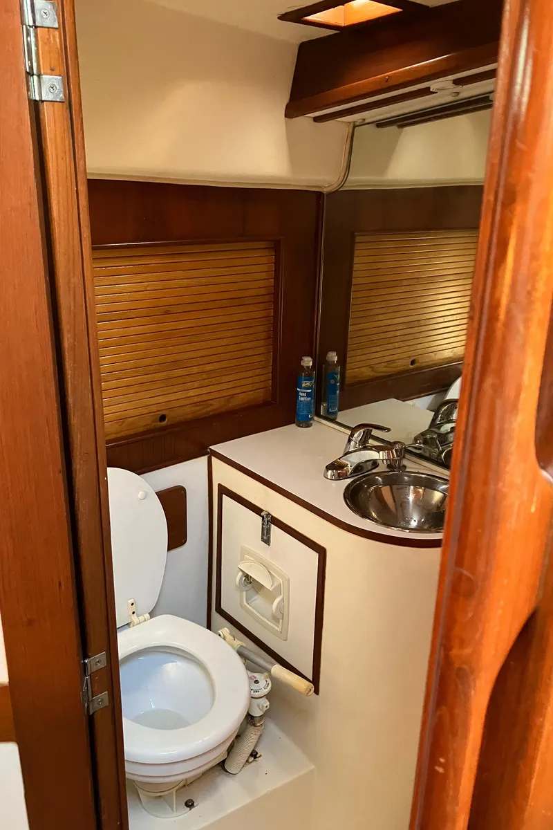 Slide: The Image of 1983 Morgan Nelson Marek 454 yacht bathroom with wooden accents and compact design. - 23