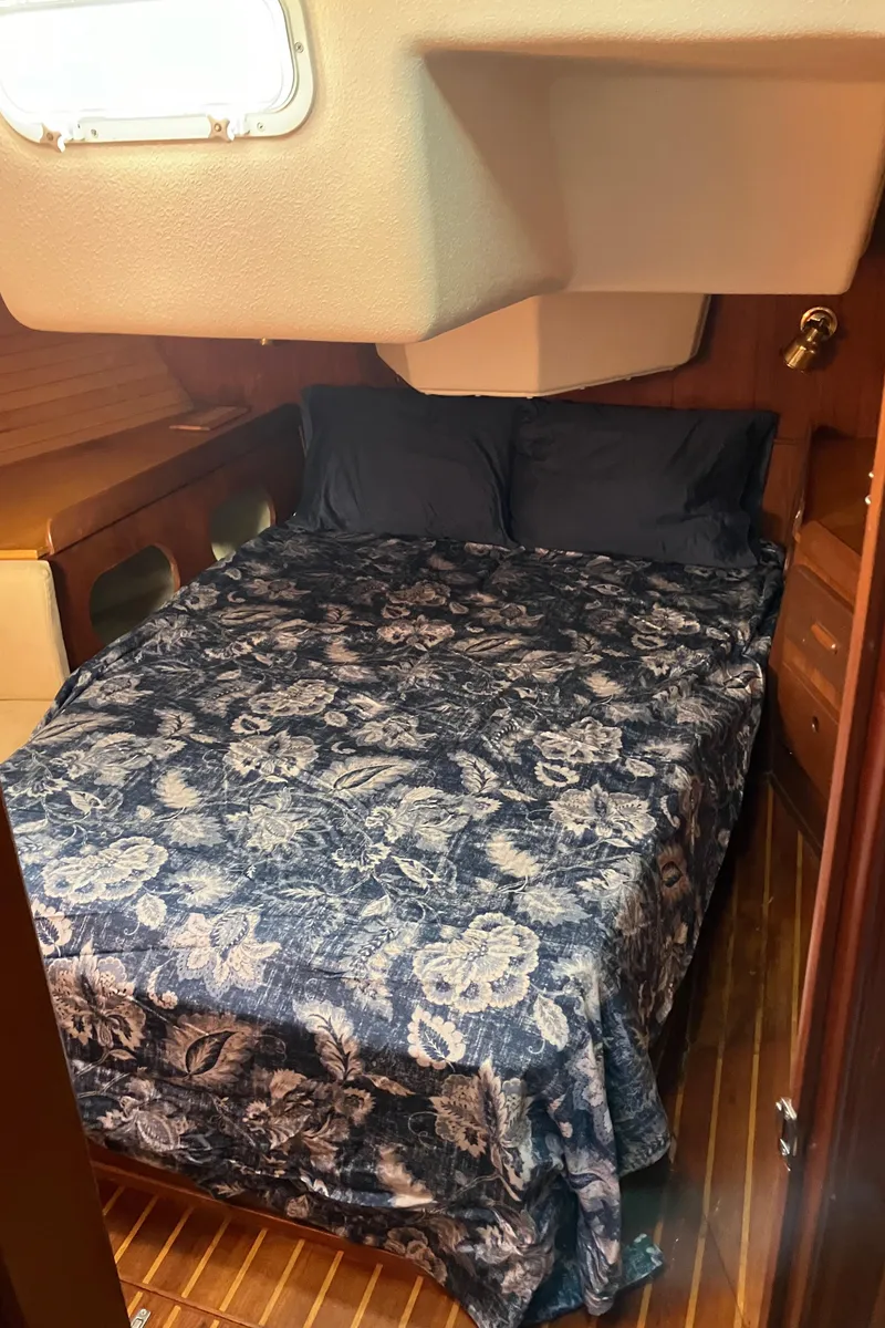 Slide: The Image of Cozy cabin interior of 1983 Morgan Nelson Marek 454 sailboat with floral bedding. - 24