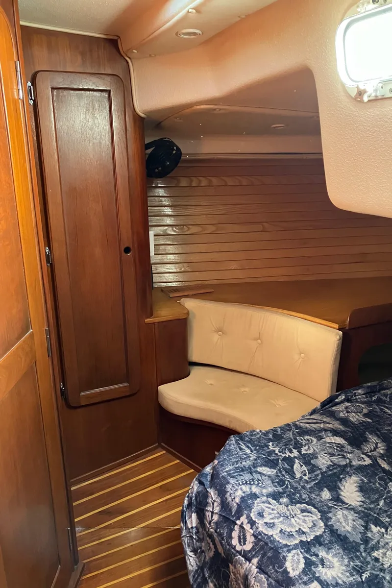 Slide: The Image of 1983 Morgan Nelson Marek 454 yacht interior with wood paneling and cozy seating area. - 25