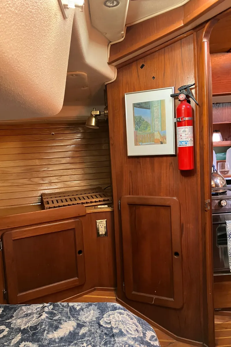 Slide: The Image of 1983 Morgan Nelson Marek 454 yacht interior with wood paneling and fire extinguisher. - 26