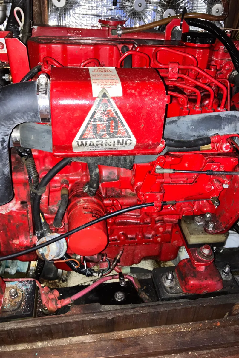 Slide: The Image of Red engine of a 1983 Morgan Nelson Marek 454 with warning label. - 28