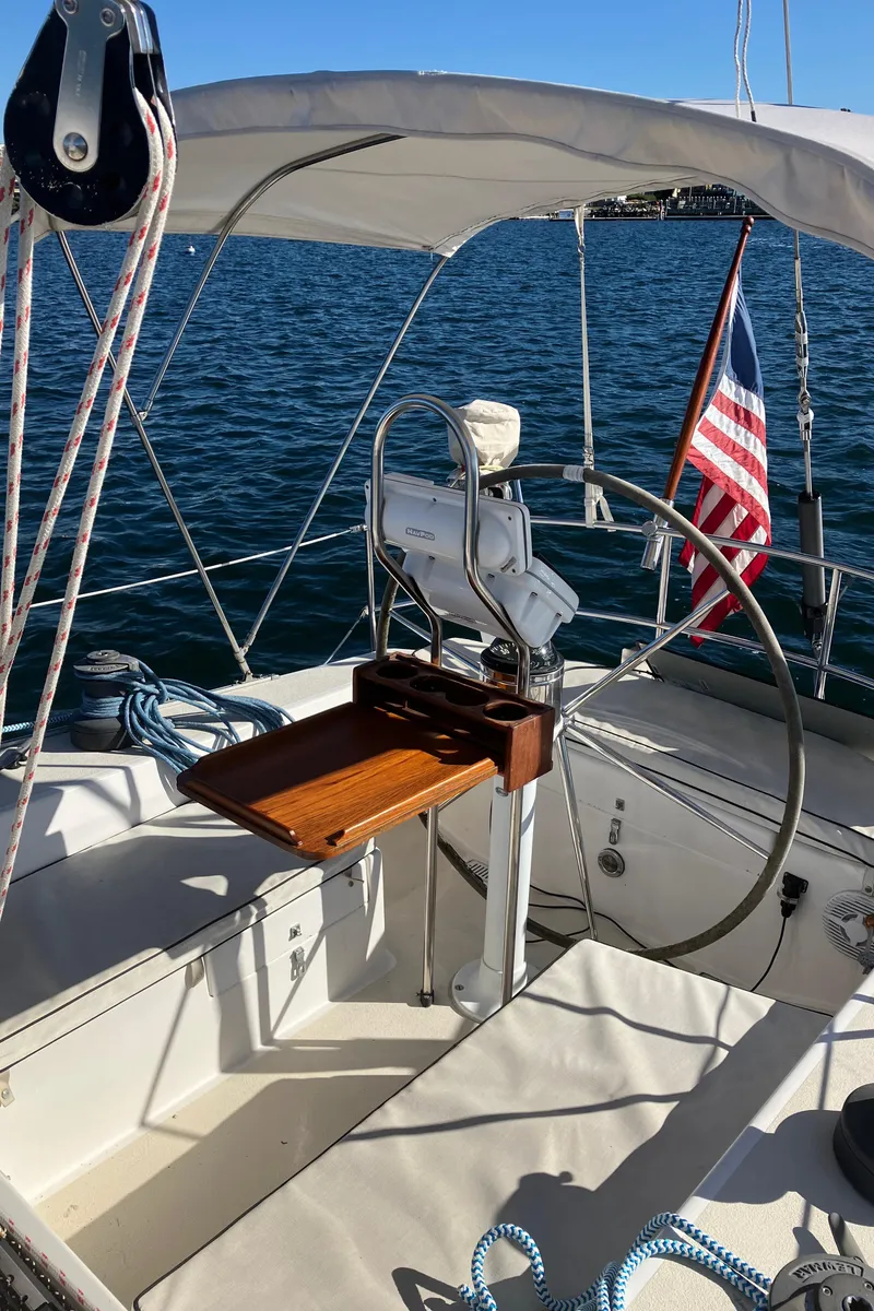 Slide: The Image of 1983 Morgan NELSON MAREK 454 sailboat cockpit with steering wheel and American flag. - 3