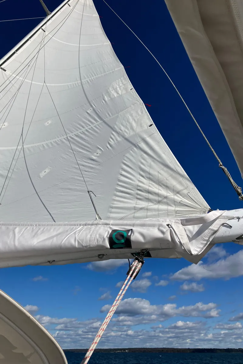 Slide: The Image of Sailing on a 1983 Morgan Nelson Marek 454 with white sails against a blue sky. - 6