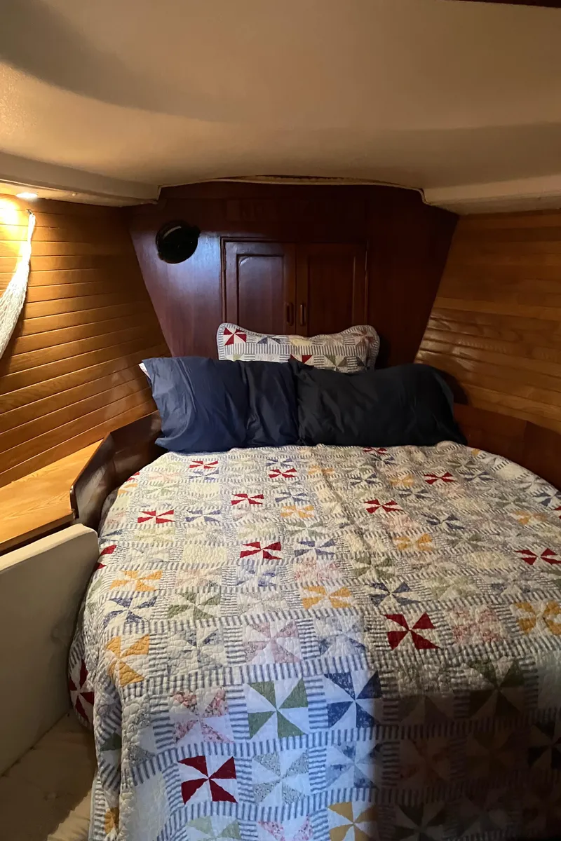 Slide: The Image of Cozy cabin interior of 1983 Morgan Nelson Marek 454 sailboat with quilted bedding. - 7