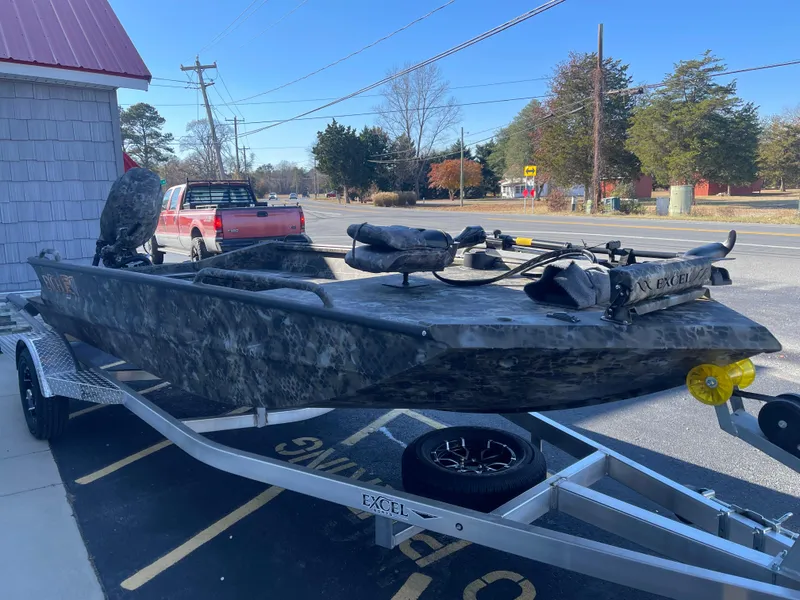 Slide: The Image of 2025 Excel 1860 F4 Shallow Water boat on trailer, parked outdoors. - 5