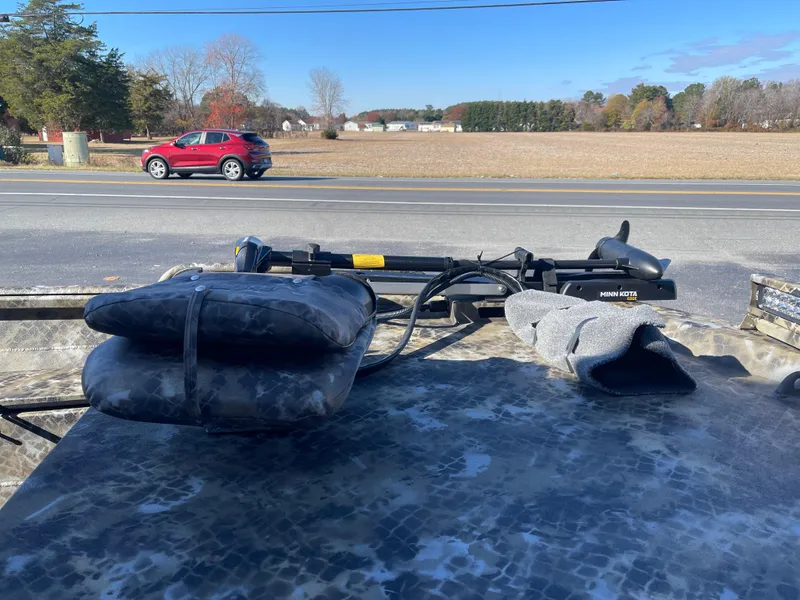 Slide: The Image of 2025 Excel 1860 F4 Shallow Water boat with equipment on deck, roadside view. - 6