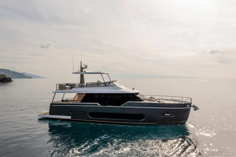Slide: The Image of 2025 Azimut Magellano 60 yacht cruising on calm waters under a cloudy sky. - 27