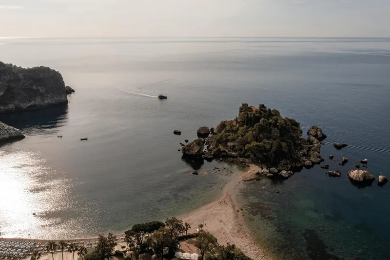 Slide: The Image of Aerial view of serene coastal landscape with Azimut Magellano 60 yacht, 2025 model, near rocky island. - 26