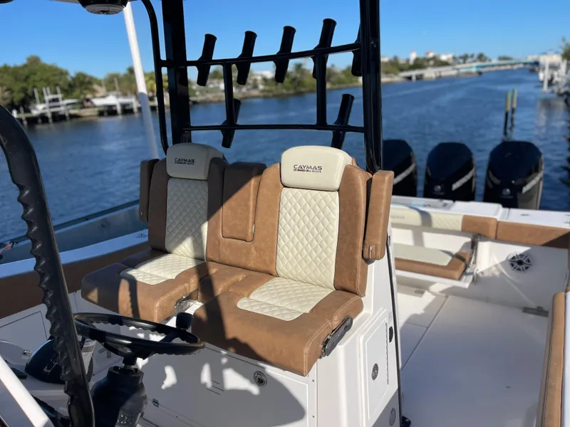 Slide: The Image of 2022 Caymas 341 CC boat interior with dual seats and multiple outboard motors. - 25