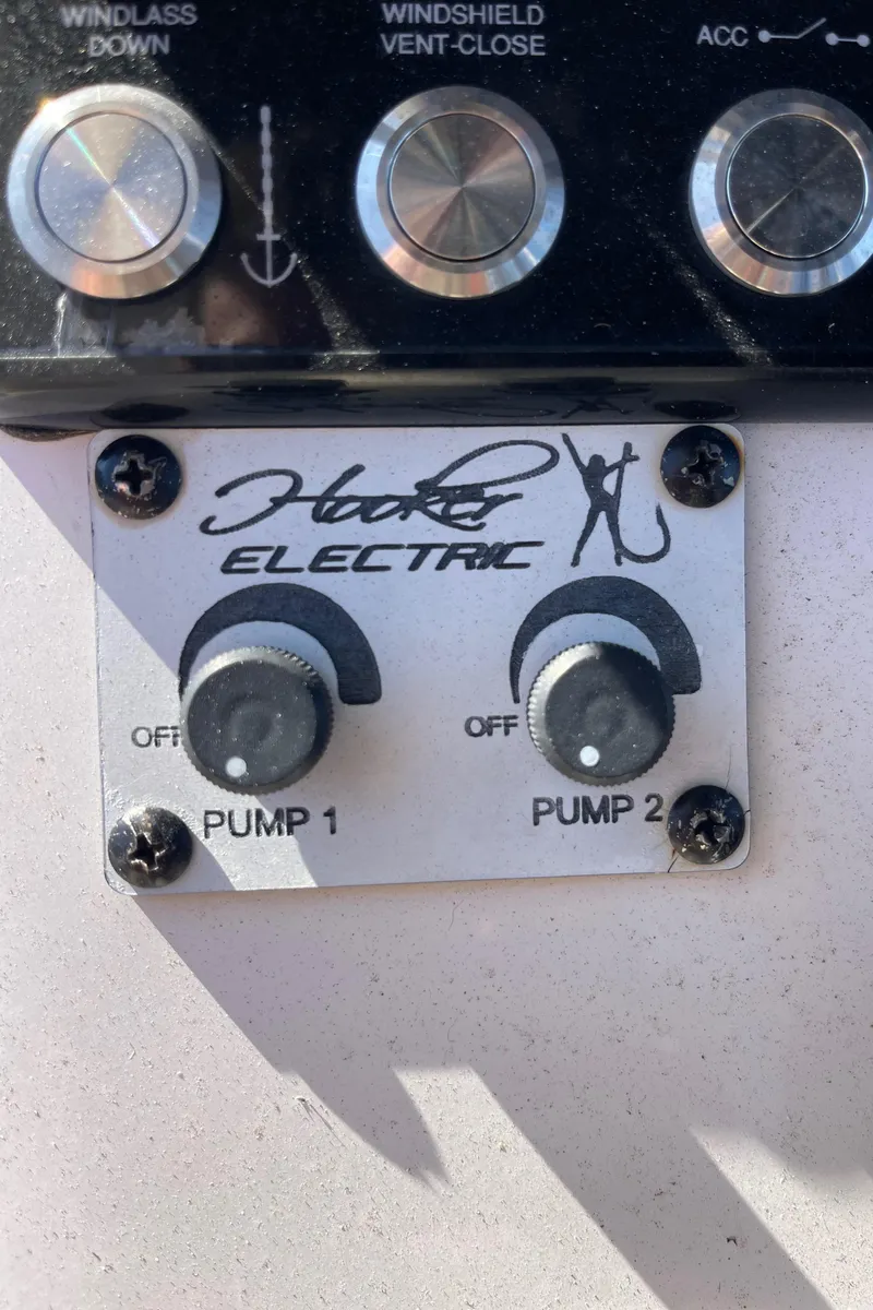 Slide: The Image of Hooker Electric pump controls on 2022 Caymas 341 CC boat dashboard. - 39