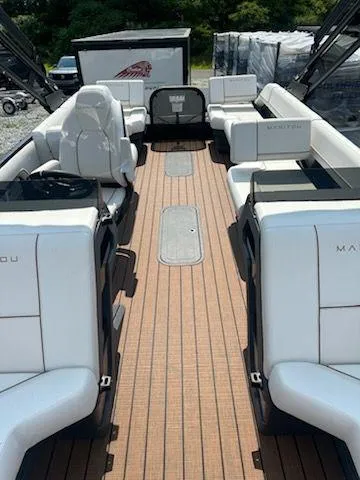 Slide: The Image of 2024 Manitou Explore Switchback 22 MAX pontoon boat with spacious seating and sleek design. - 5