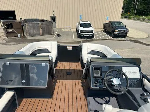 Slide: The Image of 2024 Manitou Explore Switchback 22 MAX boat interior with Garmin navigation system. - 6