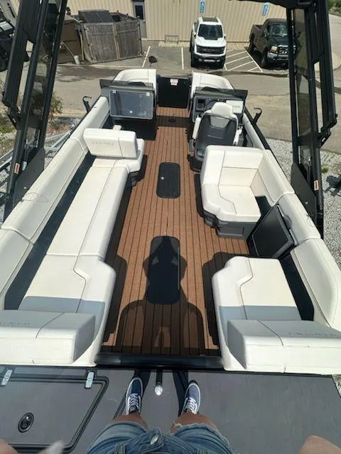 Slide: The Image of 2024 Manitou Explore Switchback 22 MAX pontoon boat with spacious seating and modern design. - 7