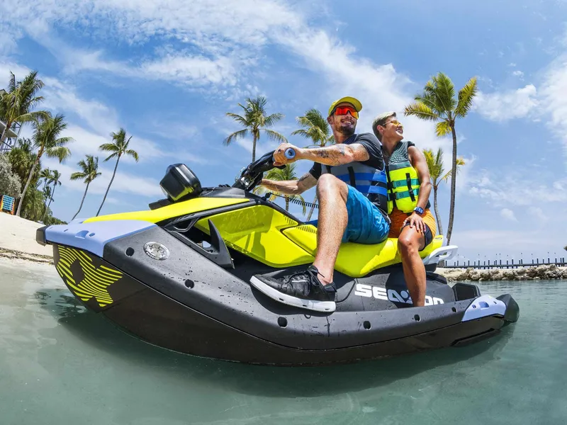 Slide: The Image of 2024 Sea-Doo SPARK TRIXX 3UP IBR jet ski on tropical beach with palm trees. - 10