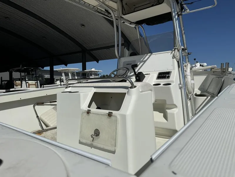 Slide: The Image of 2005 Sailfish 236 CC boat interior with steering console and seating. - 11