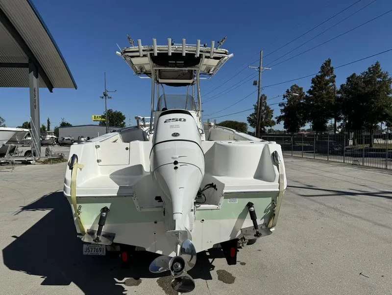 Slide: The Image of 2005 Sailfish 236 CC boat with powerful 250 HP engine, parked outdoors. - 14