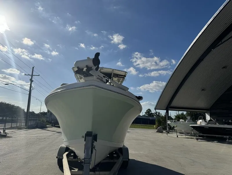 Slide: The Image of 2005 Sailfish 236 CC boat on trailer under clear blue sky. - 17