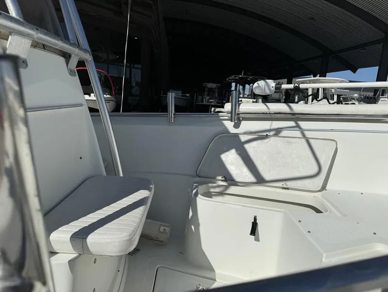 Slide: The Image of Interior view of 2005 Sailfish 236 CC boat, featuring seating and storage compartments. - 4