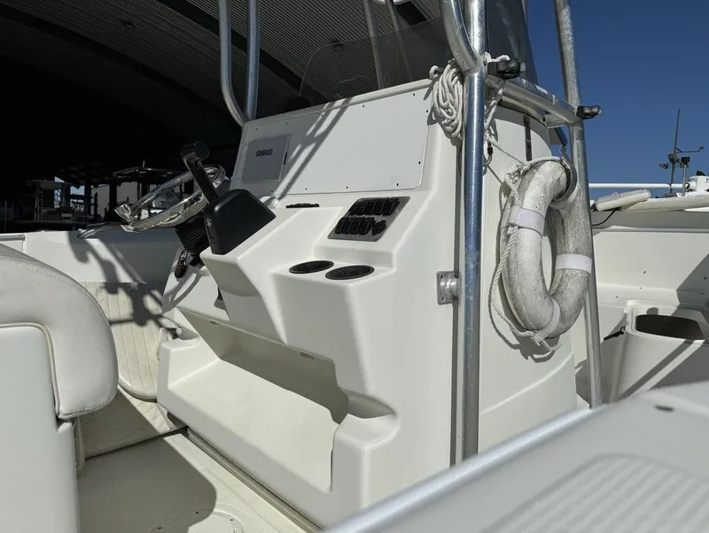 Slide: The Image of 2005 Sailfish 236 CC boat console with steering wheel and life preserver. - 5