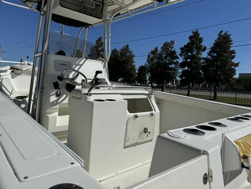 Slide: The Image of 2005 Sailfish 236 CC boat interior with steering console and rod holders. - 6