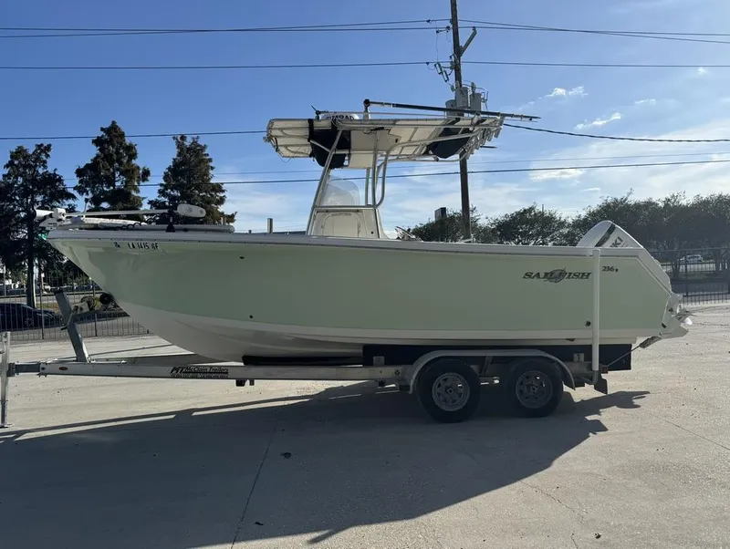 Slide: The Image of 2005 Sailfish 236 CC boat on trailer, parked outdoors under clear sky. - 9
