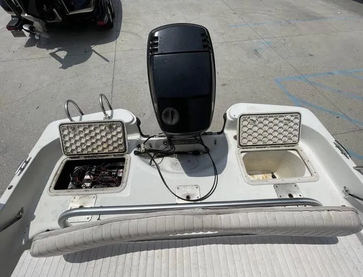 Slide: The Image of 2002 Bay Stealth 1880 BSVW boat with open storage compartments and motor, viewed from above. - 18
