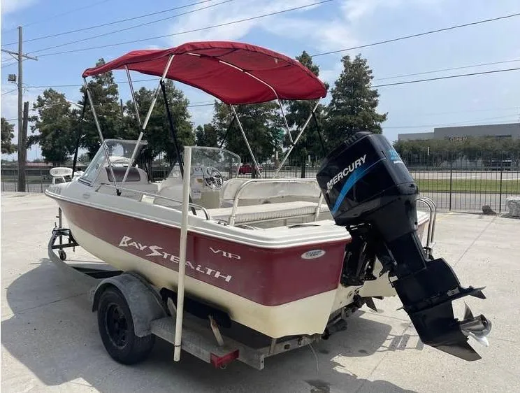Slide: The Image of 2002 Bay Stealth 1880 BSVW boat with Mercury outboard motor and red canopy. - 5