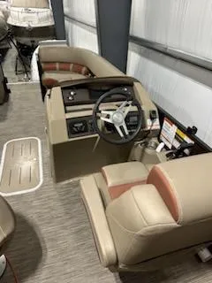 Slide: The Image of 2020 Bennington 23SPDXP boat interior with steering wheel and seating in a showroom. - 4