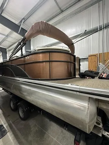 Slide: The Image of 2020 Bennington 23SPDXP pontoon boat in storage, featuring sleek design and durable construction. - 7