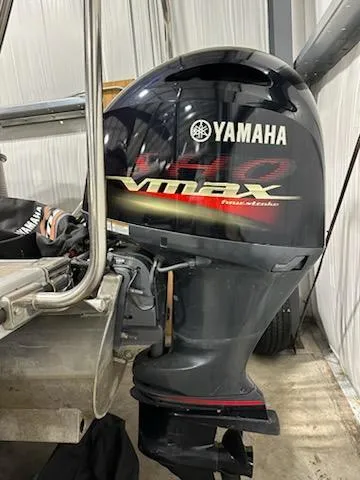 Slide: The Image of Yamaha VMAX outboard motor on a 2020 Bennington 23SPDXP boat in a storage facility. - 9