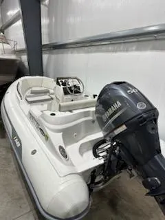 Slide: The Image of 2020 AB Inflatables 12dlx boat with Yamaha outboard motor in storage. - 4