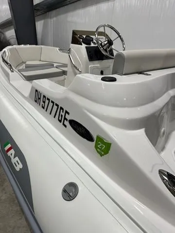 Slide: The Image of 2020 AB Inflatables 12dlx boat, white exterior, steering wheel, registration number visible. - 5