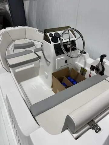 Slide: The Image of 2020 AB Inflatables 12dlx boat interior with steering wheel and seating. - 6