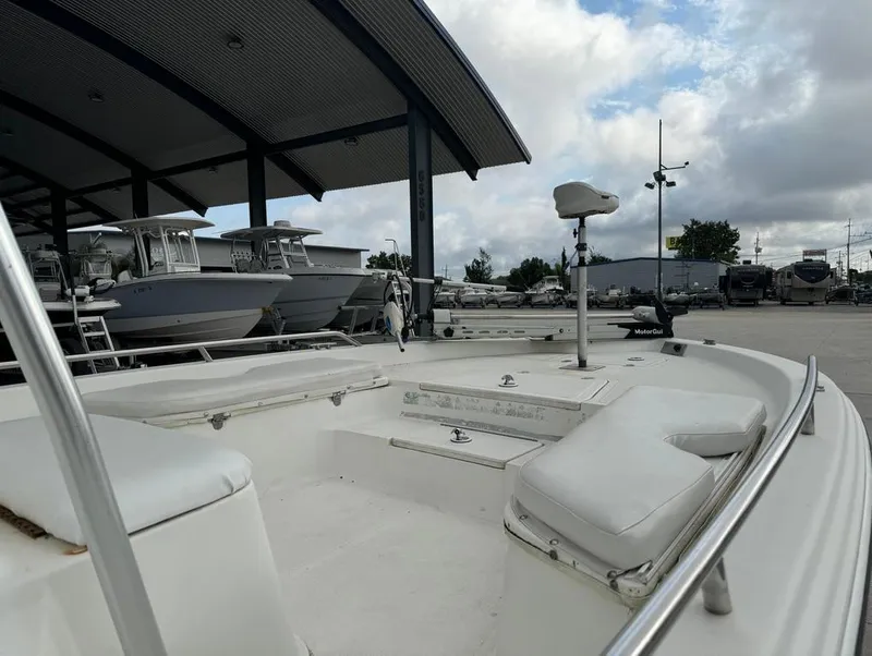 Slide: The Image of 2001 Bay Stealth 2230 boat in marina, under cloudy sky. - 12